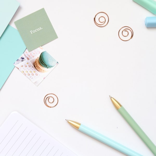 Mint stationery flat lay with pens, notepad, and creative supplies